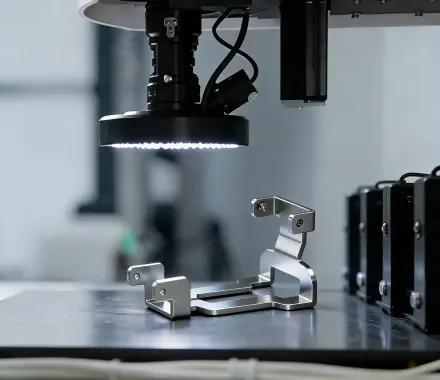 Small precision part under circular LED inspection lighting and camera